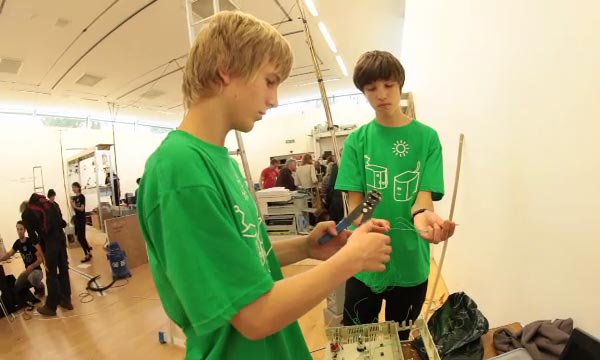 Volunteers Gwylim and Aldo working on control panel